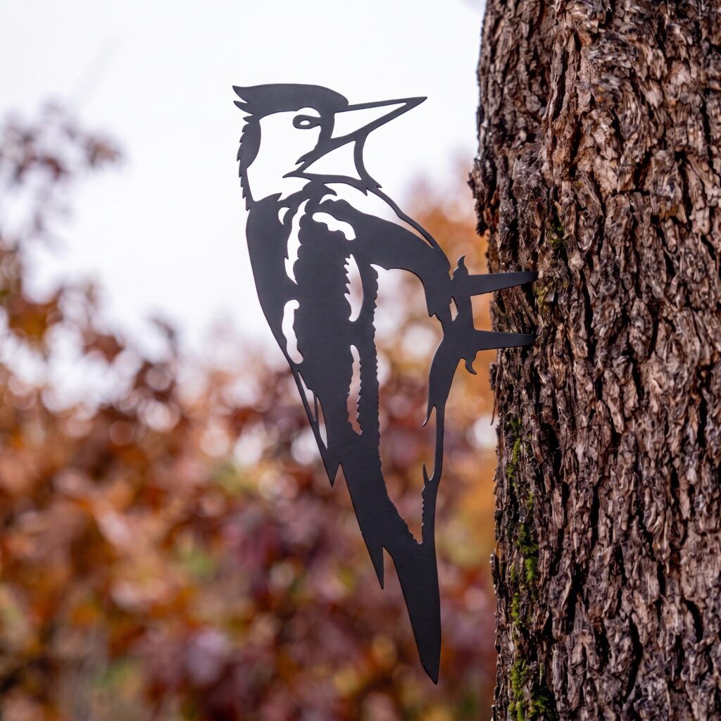 Woodpecker Stake in the Black finish on a tree in autumn